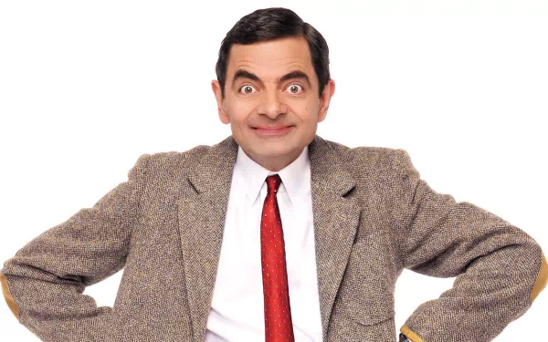 HD desktop wallpaper featuring Rowan Atkinson as Mr. Bean, dressed in a brown tweed jacket, white shirt, and red tie, set against a white background.