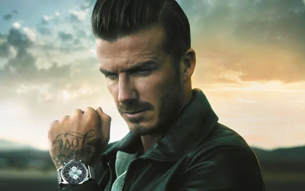 A stylized HD desktop wallpaper featuring David Beckham in a leather jacket, gazing thoughtfully with a dramatic sky backdrop, highlighting his iconic sports persona.