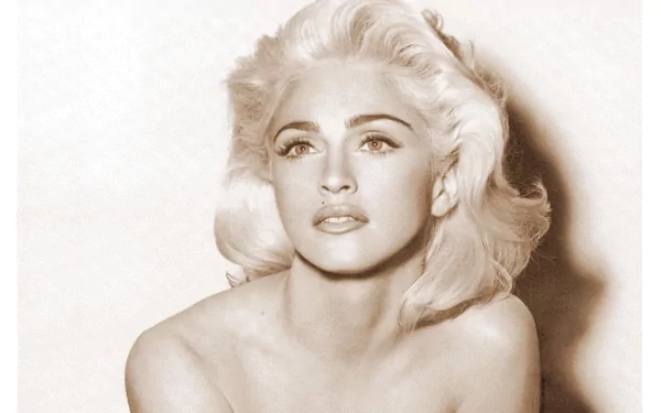 A striking black-and-white portrait of Madonna, featuring her iconic blonde hair and expressive gaze, serves as an eye-catching HD PC desktop wallpaper and background.