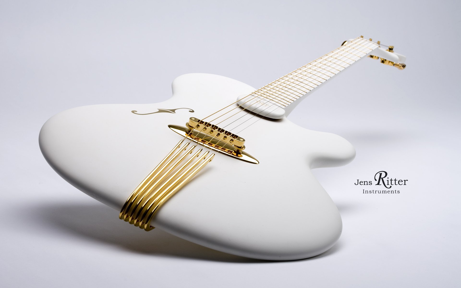 A sleek, modern white guitar with gold accents rests elegantly, showcasing its unique design, making it a striking HD PC desktop wallpaper and background for music lovers.