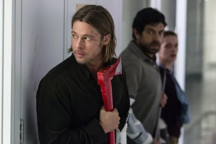 HD desktop wallpaper from the movie World War Z, showing a tense scene with Brad Pitt holding a red axe, with two men standing behind him in a corridor.