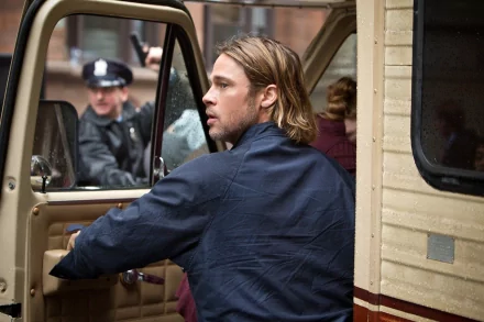 HD PC desktop wallpaper featuring a scene from the movie World War Z, showing a man in a navy jacket opening a vehicle door with a police officer in the background.