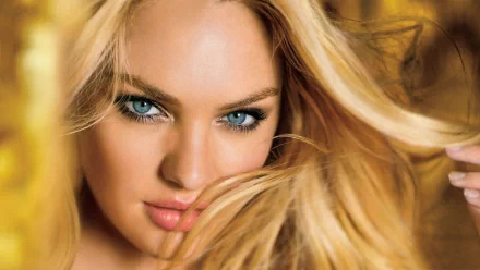 A close-up image of a woman with long blonde hair and striking blue eyes, creating an engaging backdrop for an HD PC desktop wallpaper.
