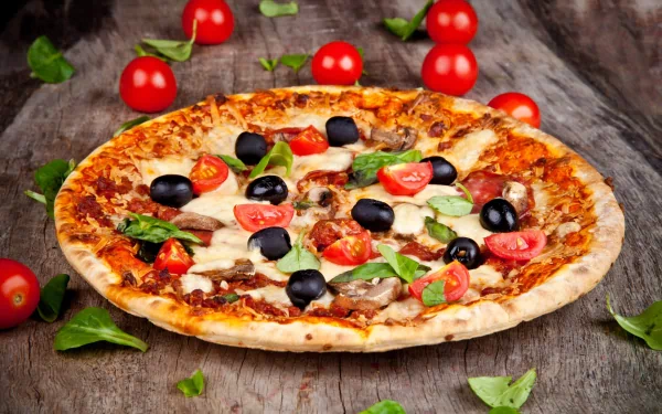 A delicious pizza topped with cherry tomatoes, olives, and fresh basil, elegantly displayed on a rustic wooden surface, creating a vibrant HD desktop wallpaper.