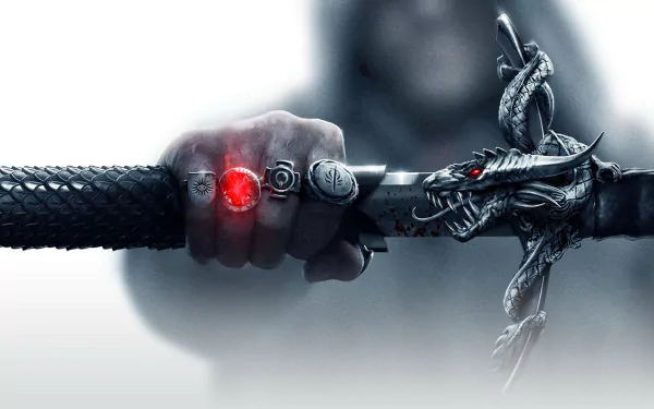 A dramatic HD wallpaper from Dragon Age: Inquisition, featuring a hand holding a sword adorned with a dragon design and glowing red gem, embodying the epic fantasy of the video game.