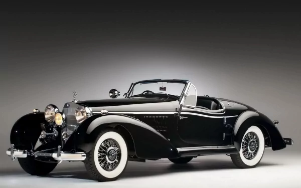 HD PC desktop wallpaper featuring a classic black Mercedes-Benz convertible with whitewall tires against a simple gray gradient background.