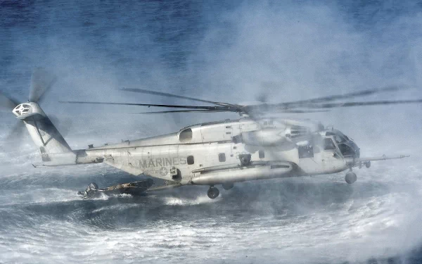 Military Sikorsky CH-53E Super Stallion helicopter flies low over rough sea waves in this HD PC desktop wallpaper and background.