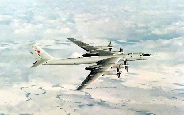 A Tupolev Tu-95 bomber soars above the clouds, showcasing its sleek design. This high-definition image serves as a striking PC desktop wallpaper and background for enthusiasts of military aviation.