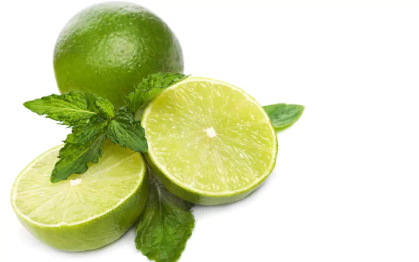 HD PC desktop wallpaper featuring fresh green limes and mint leaves against a clean white background, highlighting vibrant food colors and textures.