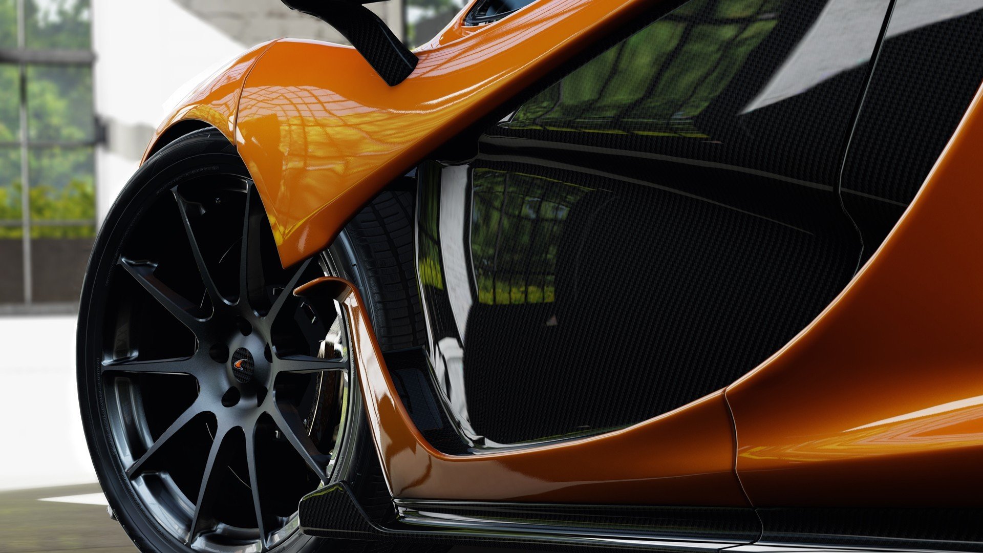 HD PC desktop wallpaper and background: close-up of an orange McLaren vehicle, highlighting the wheel, carbon-fiber side panel and glossy reflections.