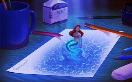 A whimsical HD wallpaper featuring Ariel from The Little Mermaid (1989), depicting her sitting on a drawing of water, surrounded by art supplies and a creative workspace.
