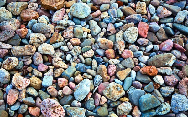 HD PC desktop wallpaper featuring a close-up view of various colorful, smooth stones arranged naturally, showcasing the intricate beauty of nature's textures.