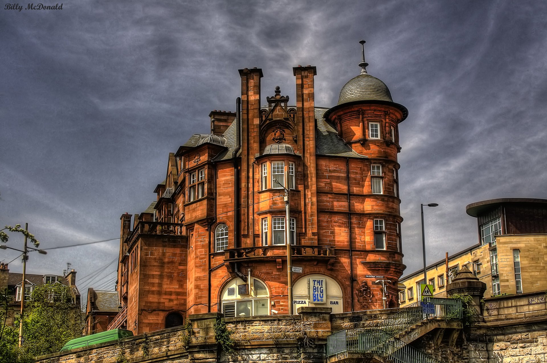 HD desktop wallpaper featuring a historic, man-made building with intricate architecture under a dramatic cloudy sky.