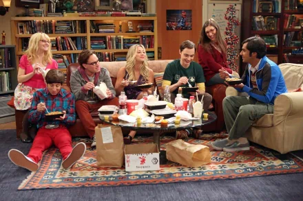 The cast of The Big Bang Theory including Raj, Amy, Sheldon, Penny, Leonard, Bernadette, and Howard enjoy a meal together in a cozy living room setting. HD wallpaper for desktop background.