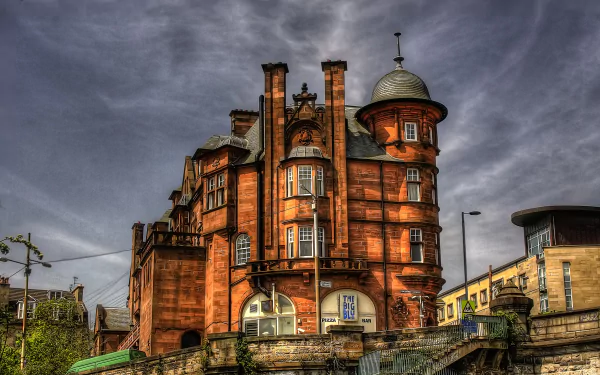 HD desktop wallpaper featuring a historic, man-made building with intricate architecture under a dramatic cloudy sky.