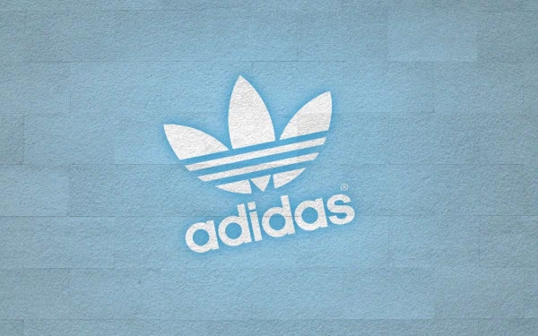 A high-definition desktop wallpaper featuring the iconic Adidas logo against a textured light blue background, showcasing a modern and stylish design.