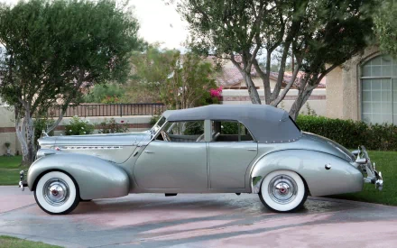A silver Packard Eight vintage vehicle parked on a residential driveway, captured in high definition as a PC desktop wallpaper and background.