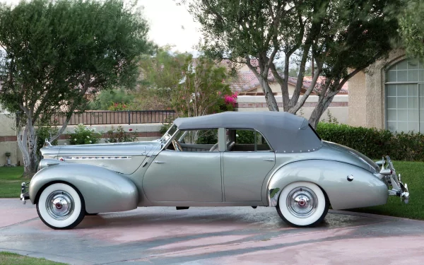A silver Packard Eight vintage vehicle parked on a residential driveway, captured in high definition as a PC desktop wallpaper and background.
