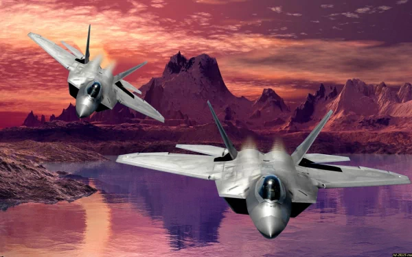 Two Lockheed Martin F-22 Raptors soar over a vibrant landscape at sunset, showcasing the elegance and power of military aviation in a stunning HD desktop wallpaper.