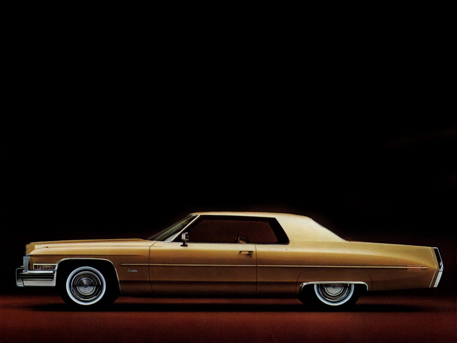 Side profile of a gold 1973 Cadillac Fleetwood vehicle on a black background, HD PC desktop wallpaper.
