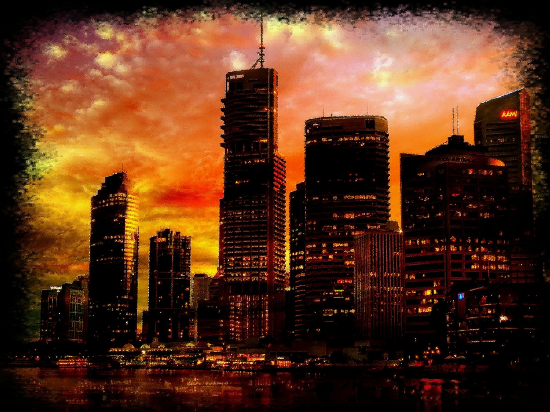 Artistic HD PC desktop wallpaper featuring a city skyline at sunset, with vibrant orange and red hues casting dramatic light on skyscrapers.
