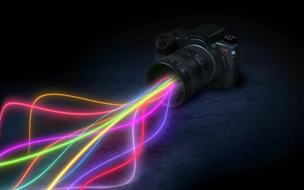 A vibrant HD desktop wallpaper featuring a camera with colorful light streaks emanating from its lens, blending technology and artistry.