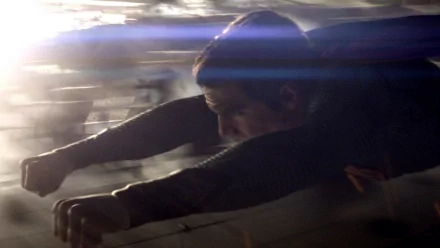 HD PC desktop wallpaper from the movie Man of Steel: a dark‑suited superhero flying in motion, blurred city below and streaks of light across the frame.