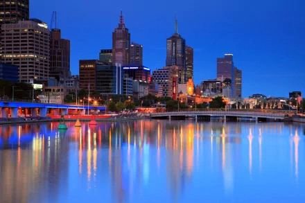 A stunning HD image of Melbourne's skyline at dusk, showcasing the vibrant city lights reflecting on the Yarra River, capturing the charm of this man-made Australian metropolis.