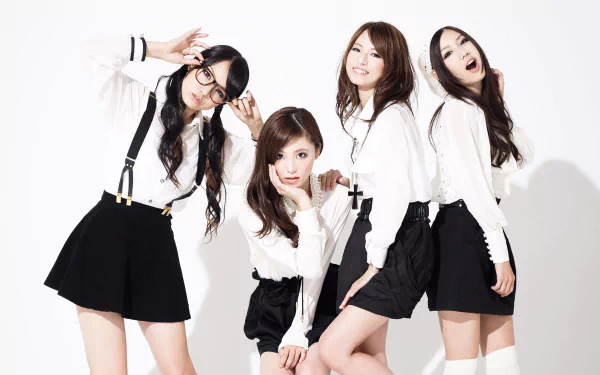 HD PC desktop wallpaper, music-themed Scandal design: four young women in coordinated black-and-white outfits posing energetically against a white background.