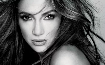 A stunning high-definition black and white portrait of Jennifer Lopez, capturing her captivating gaze and flowing hair, making it a striking desktop wallpaper.