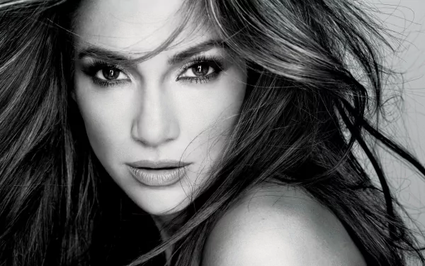 A stunning high-definition black and white portrait of Jennifer Lopez, capturing her captivating gaze and flowing hair, making it a striking desktop wallpaper.