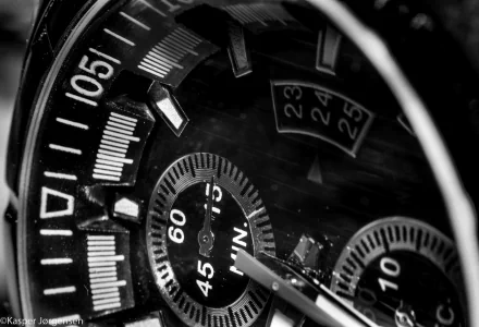 Close-up reversed macro shot of a detailed watch face captured with a Nikon, rendered in 4K Ultra HD as a striking PC desktop wallpaper and background.