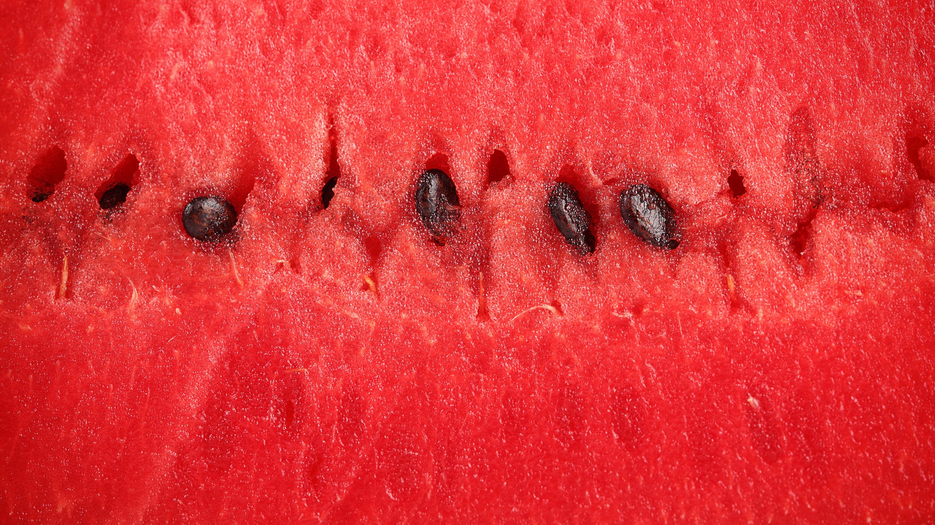 Close-up of vibrant watermelon flesh and seeds, captured in HD for a striking PC desktop wallpaper background.