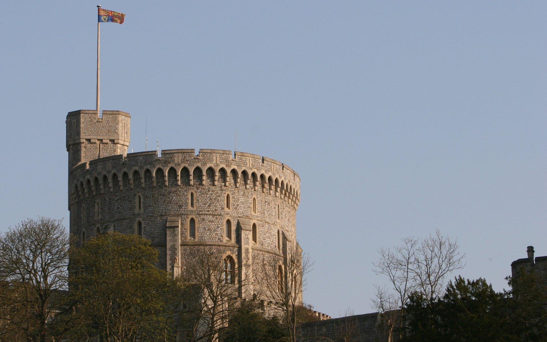 Man-made Windsor Castle round tower with flag above treetops, captured as a 2K Quad HD PC desktop wallpaper/background.