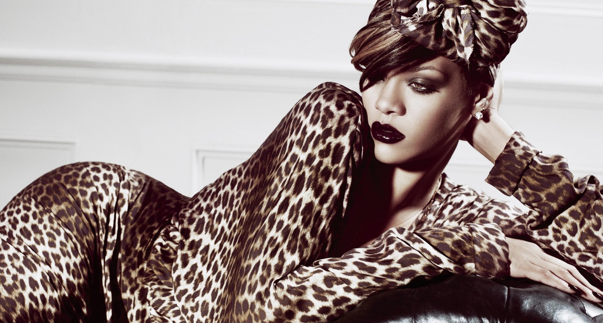 HD desktop wallpaper of Rihanna in a leopard print outfit and headwrap, with bold makeup, representing her music persona.