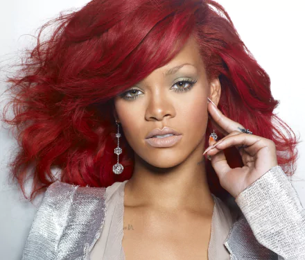 Bold HD wallpaper featuring Rihanna with vibrant red hair, showcasing her striking makeup and confident pose. A perfect choice for music fans and desktop backgrounds.