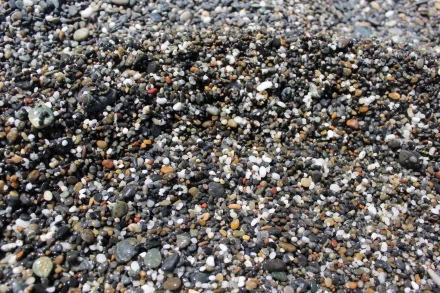 HD wallpaper featuring a close-up of multicolored pebbles for a textured stone background.