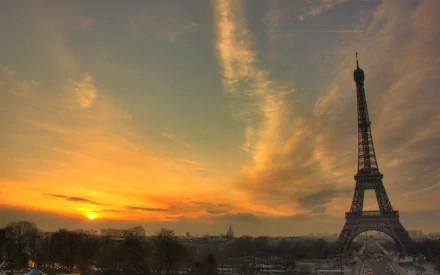 HD desktop wallpaper featuring the man-made Eiffel Tower silhouetted against a vibrant sunset sky.