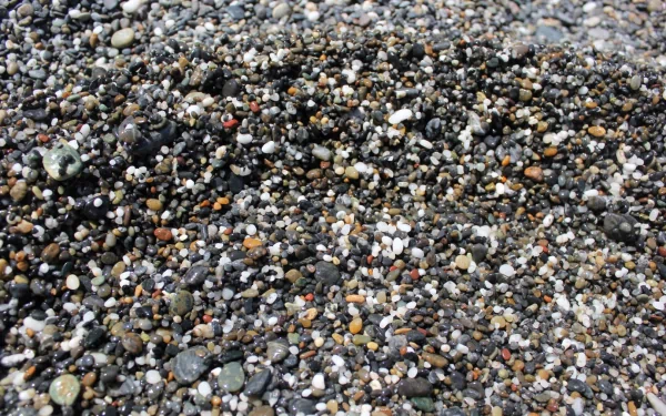 HD wallpaper featuring a close-up of multicolored pebbles for a textured stone background.