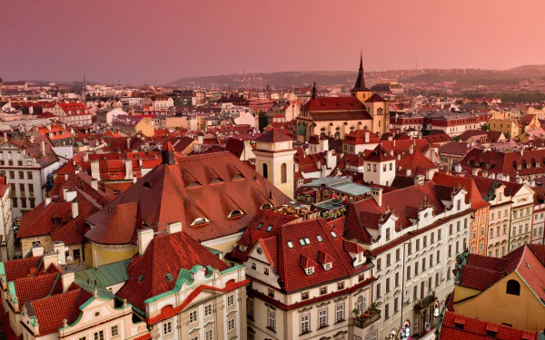 HD PC desktop wallpaper of Prague, Czech Republic: panoramic view of man-made historic buildings with red roofs, baroque facades and church spires.