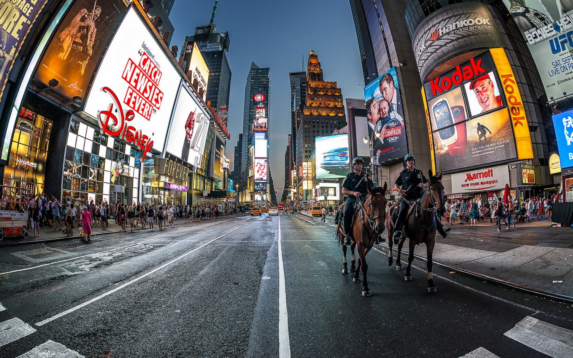 HD PC desktop wallpaper/background: man-made Manhattan Times Square at night, wide-angle of bright billboards, wet avenue and mounted officers riding through the bustling city.