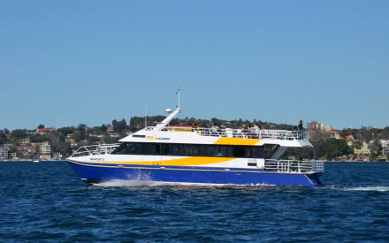 A colorful passenger ferry glides through the waters of Sydney, showcasing the vibrant landscape and transportation options available in this picturesque city.