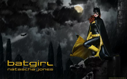 A dynamic HD desktop wallpaper featuring Batgirl, portrayed by Natascha Jones, in a moody, stormy scene with clouds and a full moon, exuding strength and heroism.