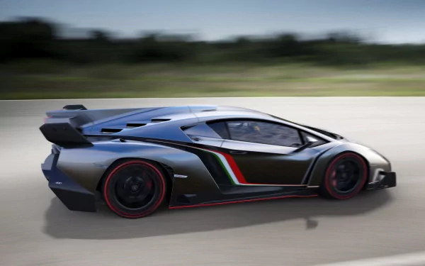 HD desktop wallpaper showing a sleek Lamborghini Veneno speeding on a flat road with a blurred background. The vehicle's futuristic design and bold colors highlight its high-performance nature.