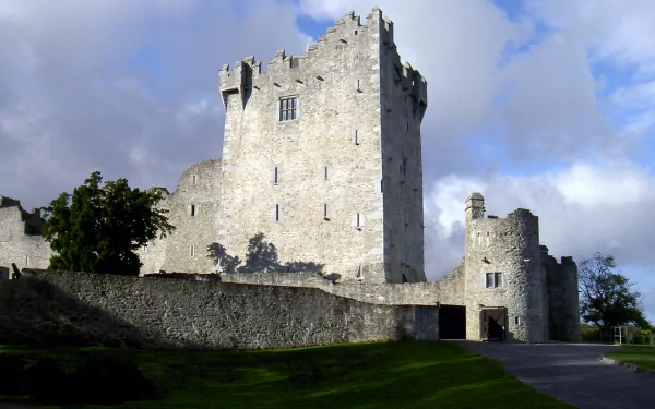 HD desktop wallpaper featuring the man-made historic Ross Castle under a partly cloudy sky with green grass in the foreground.