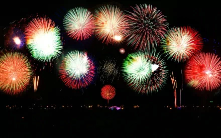 HD desktop wallpaper featuring vibrant fireworks bursting in a night sky, showcasing colorful photography capturing festive celebrations.