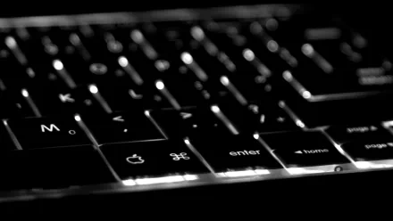 A close-up of a backlit keyboard, showcasing the sleek design and illuminated keys, serves as a striking HD PC desktop wallpaper and background focused on technology.