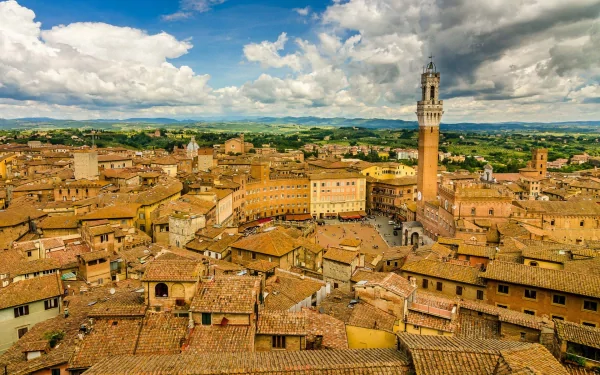 HD PC desktop wallpaper and background: man-made cityscape of Siena with terracotta rooftops and the Torre del Mangia beneath a dramatic sky.