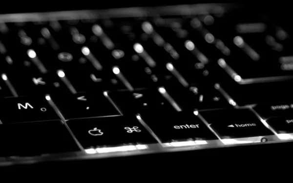 A close-up of a backlit keyboard, showcasing the sleek design and illuminated keys, serves as a striking HD PC desktop wallpaper and background focused on technology.