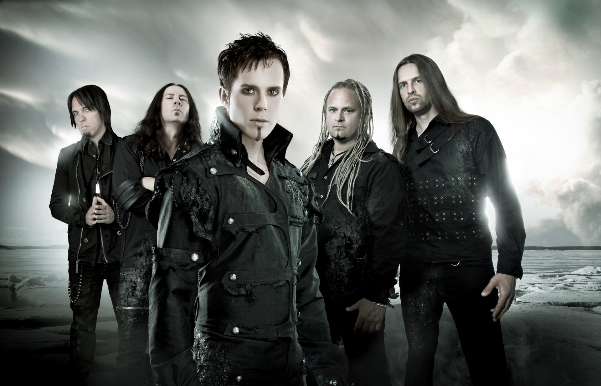HD desktop wallpaper featuring the band Kamelot, with its five members standing against a moody, cloudy background, representing music and rock themes.